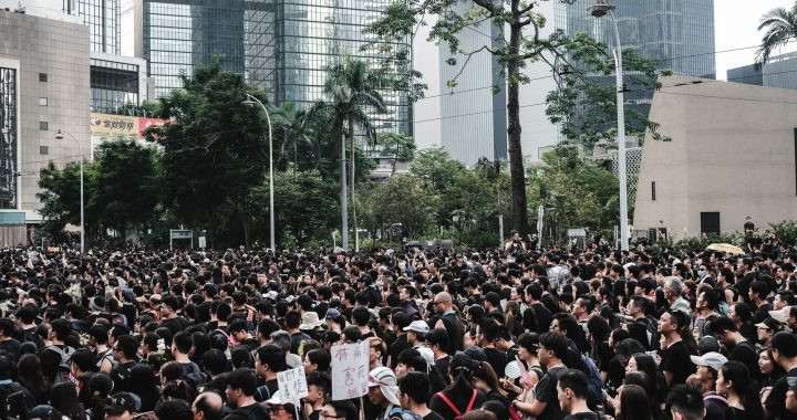 Massive crowd gathers during a protest in Hong Kong's urban district, showcasing urban activism. — Coronavirus disease 2019