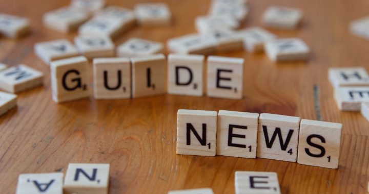 Close-up of Scrabble tiles spelling 'Guide' and 'News' on a wooden surface. — Join the Elite Unique Casino Experience